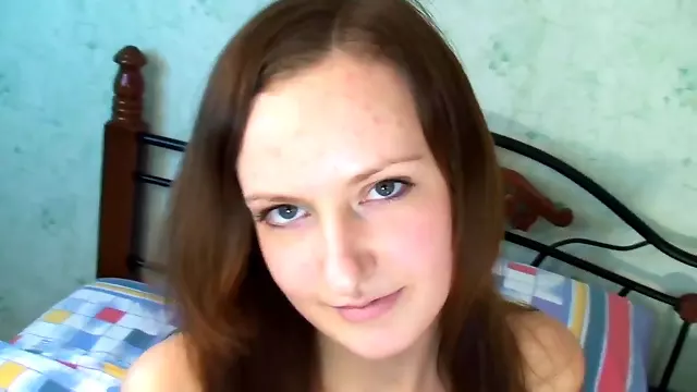 Flirty dark haired girl rubs her pussy slit in bed