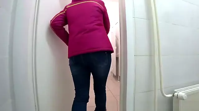 pissing a young girl in a public toilet